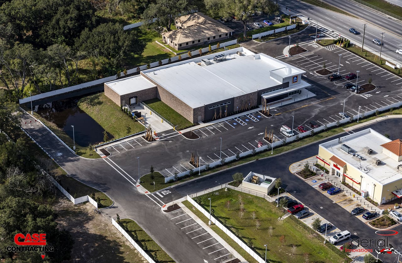 Aerial view of Case Contracting commercial property with parking lot and landscaped area.