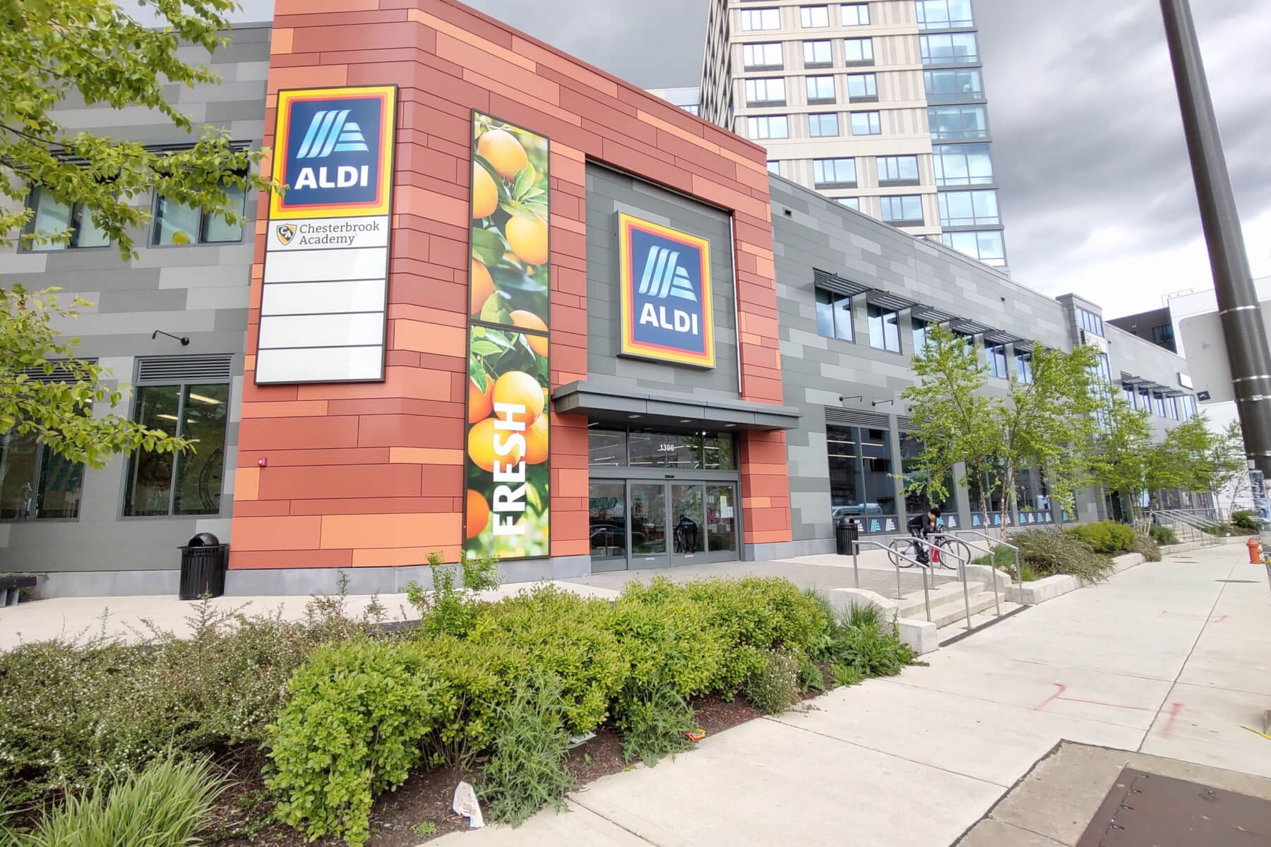Exterior view of ALDI store entrance with fresh produce signage.