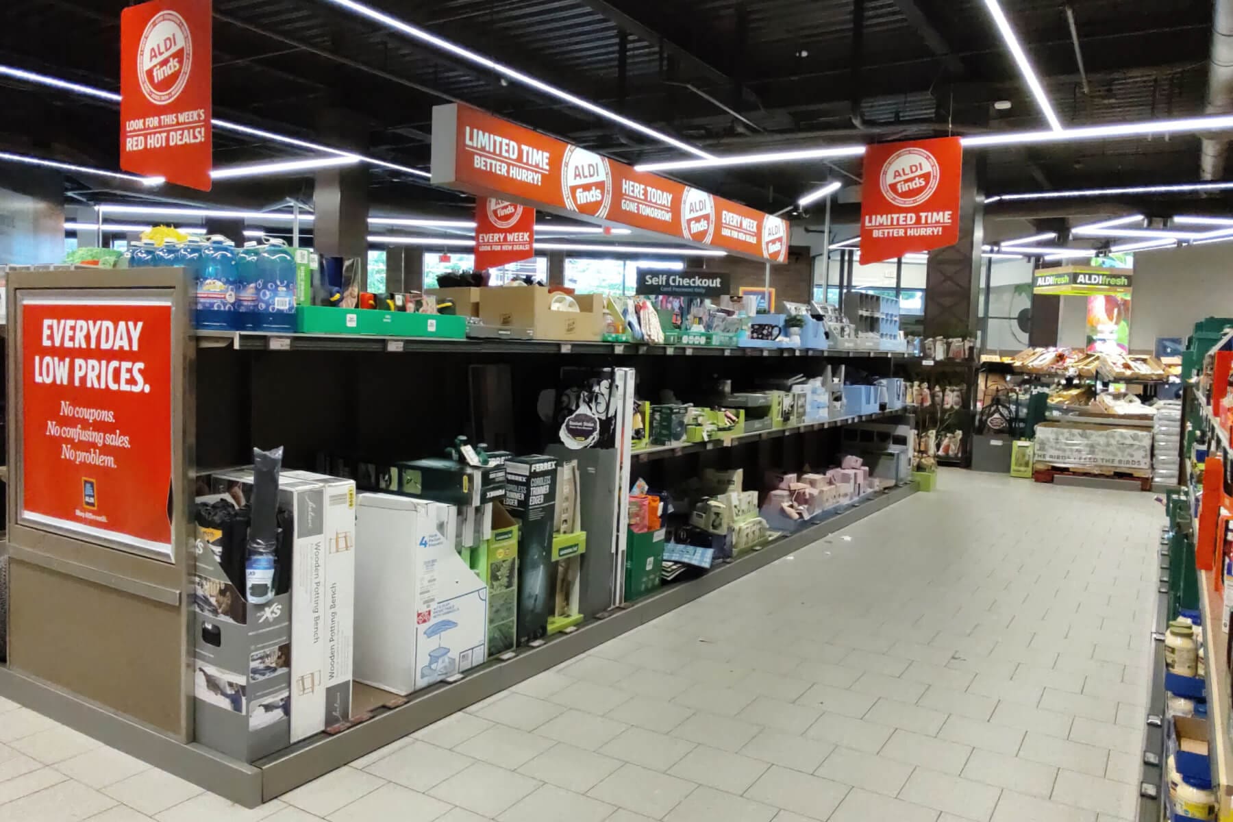 Store aisle with Aldi Finds, promoting limited-time deals and everyday low prices. Explore weekly savings and offers.