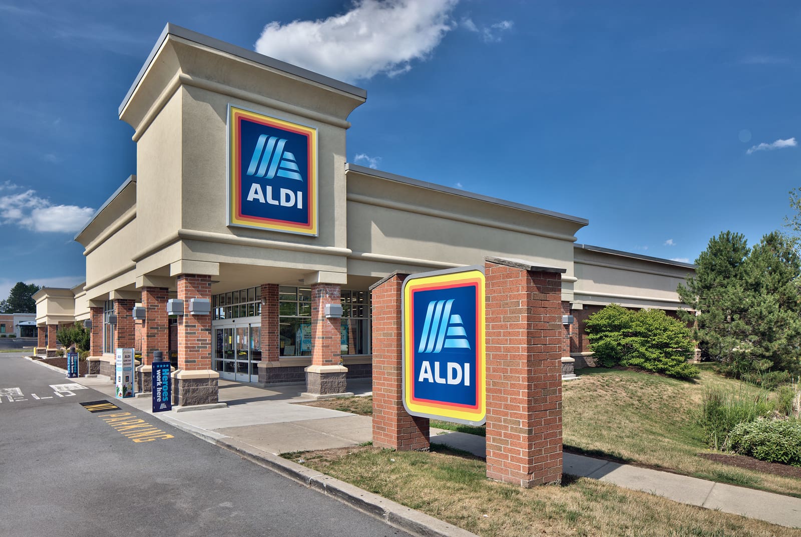Exterior view of an ALDI supermarket with branded signage on a sunny day.
