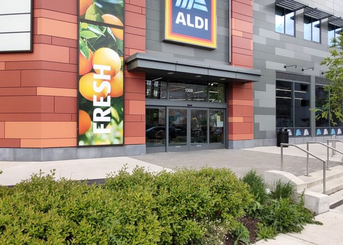 Entrance of Aldi grocery store featuring fresh produce signage.