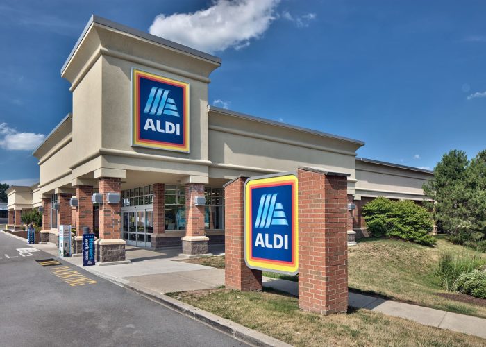 Exterior view of an Aldi grocery store with branded signage on a sunny day.