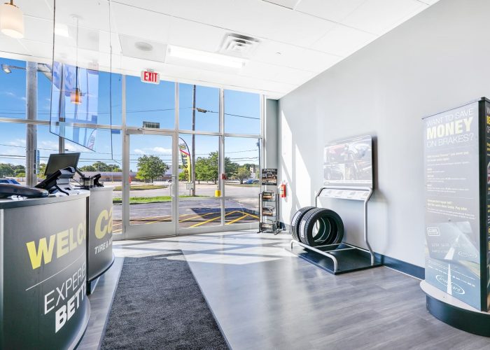 Entrance of a modern tire shop showcasing the reception area and product display.