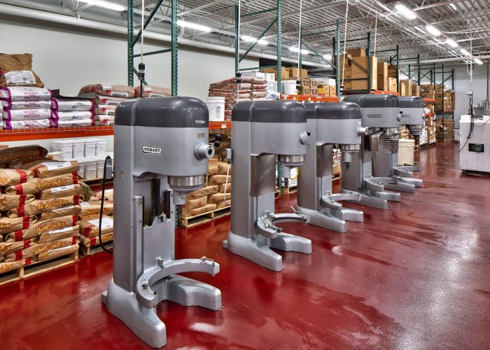 Industrial mixers in a commercial kitchen, ready for bulk baking tasks, at Hobart Facility.