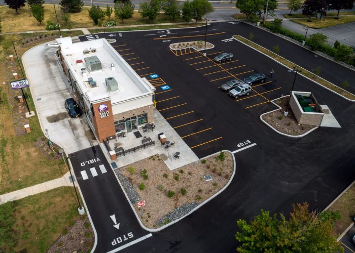 Aerial view of Taco Bell drive-thru and parking lot, showcasing accessibility with ample parking spaces.