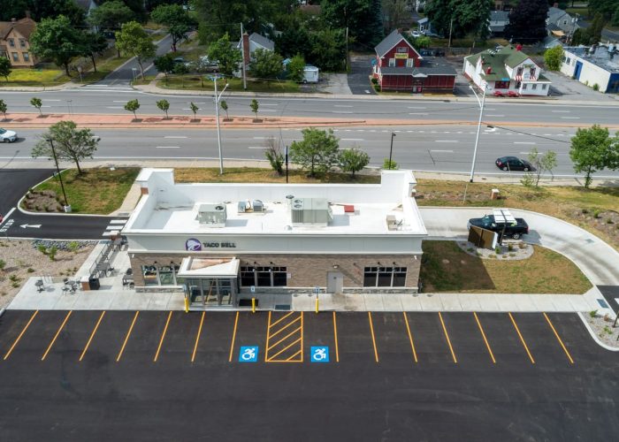 Aerial view of Taco Bell with new drive-thru lane and parking lot on a sunny day.