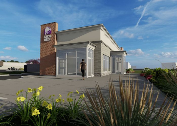 Exterior view of a modern Taco Bell restaurant on a sunny day with clear skies.