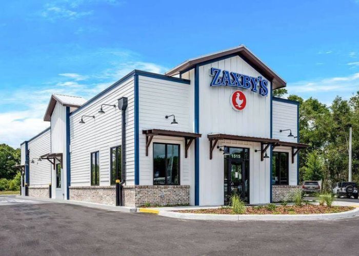 Exterior view of a Zaxby's restaurant location, featuring modern design and clear blue sky.
