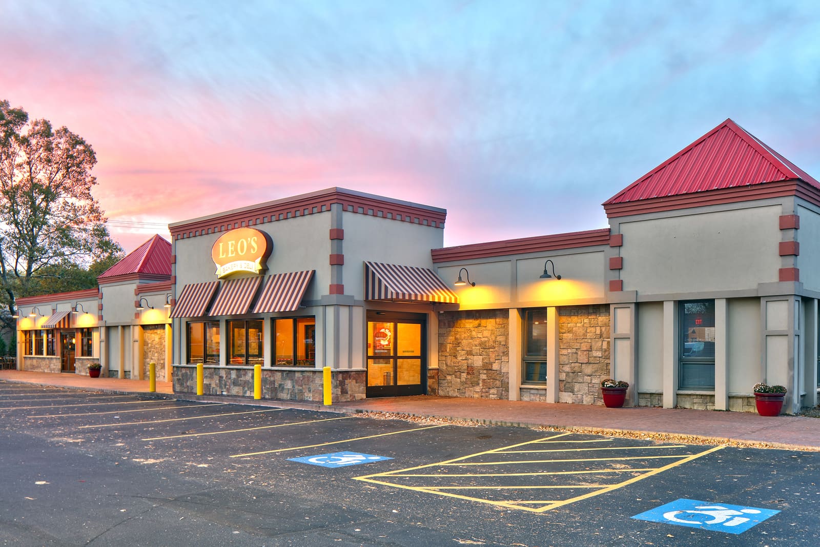 Leo's Diner exterior at sunset with accessible parking. Perfect for family dining and comfort food cravings.